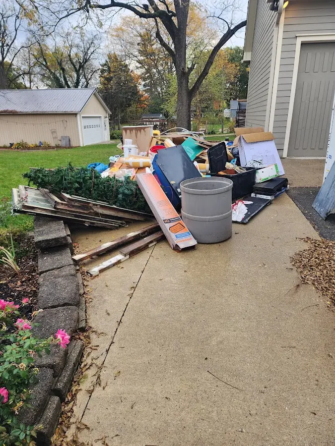 Dumpster being loaded with debris for Demolition Dumpster Rental in New York Mills